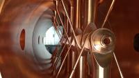 Close-up photo of linac booster, a two-meter-long series of copper tubes fitted onto an accelerator